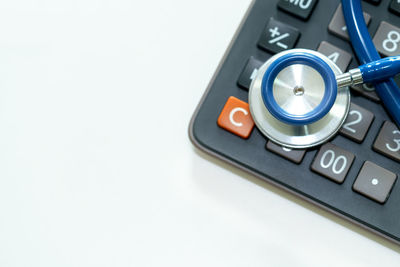 High angle view of camera on table against white background