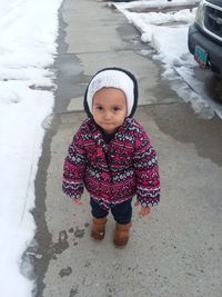 Cute girl standing in snow