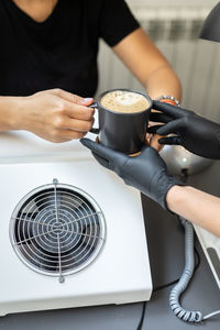 Midsection of man holding coffee