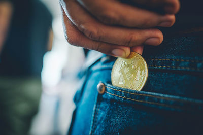 Close-up of a hand holding coin