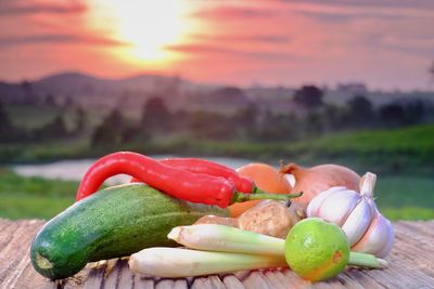 Close-up of fresh fruits against sky during sunset