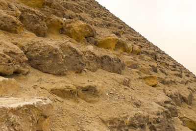 Low angle view of rock formation against sky