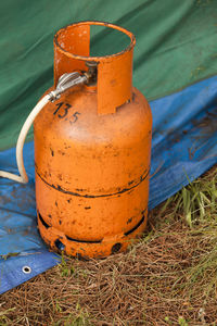 Orange gas cylinder on land