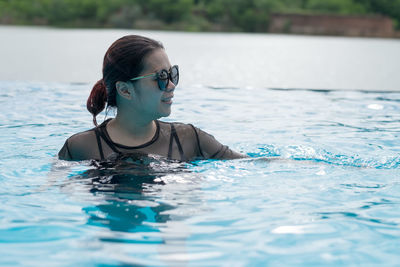 Young woman swimming in pool