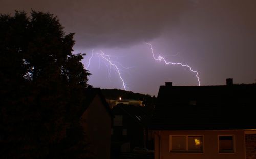 Low angle view of illuminated building against sky at night
