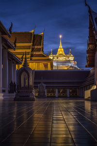 Illuminated temple building against sky at dusk