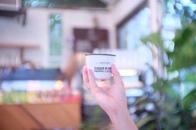 Midsection of person holding text at store