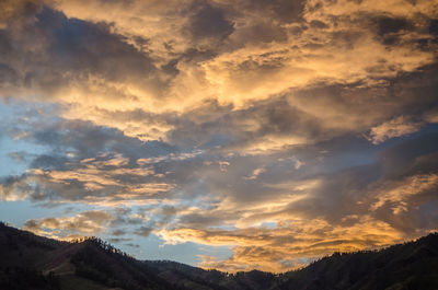 Low angle view of mountains against sky at sunset
