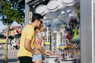 Young couple looking at market in store