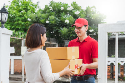 Young couple holding hands in box