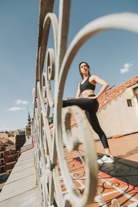 Sportwoman stretching on a rooftop. healthcare lifestyle concept.