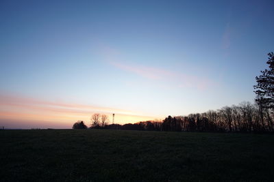 Scenic view of field against sky during sunset