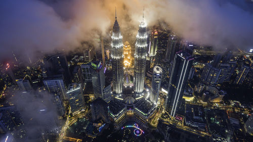 High angle view of city lit up at night