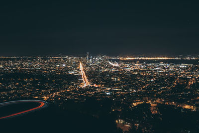 Aerial view of illuminated city against sky at night