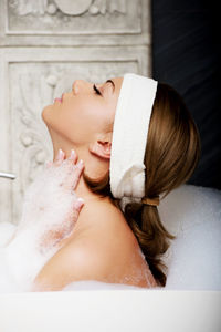 Woman taking bath in tub