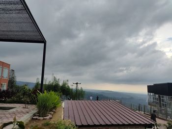 Buildings against cloudy sky