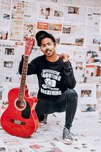 Portrait of a young man playing guitar