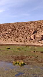 Scenic view of arid landscape against sky