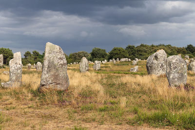 Stone wall on field against sky