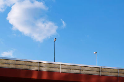 Low angle view of street light against blue sky