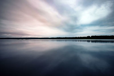 Scenic view of lake against sky at sunset