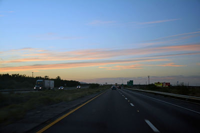 Highway against sky during sunset