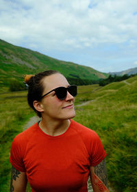 Portrait of young woman standing on field