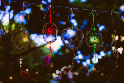 Close-up of illuminated christmas lights hanging at night