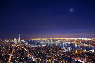 High angle view of illuminated city buildings at night