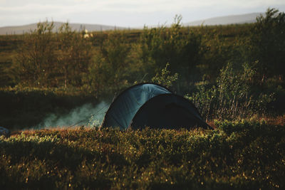 Tent on field against sky