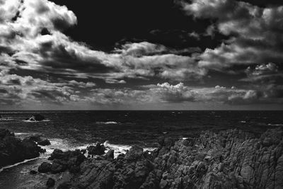 Scenic view of sea against cloudy sky