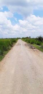 Dirt road along countryside landscape