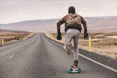 Man skateboarding on highway