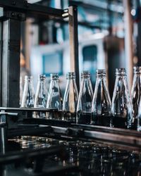 Close-up of bottles in factory