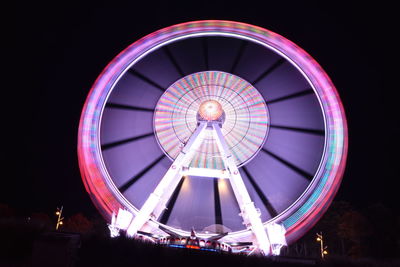 Low angle view of illuminated ferris wheel at night