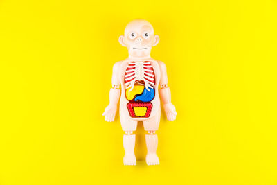 Toy standing against yellow background