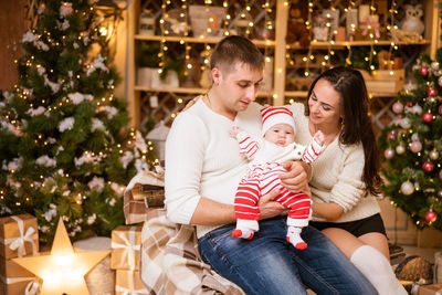 Family, winter holidays and people concept - happy young parents and little son