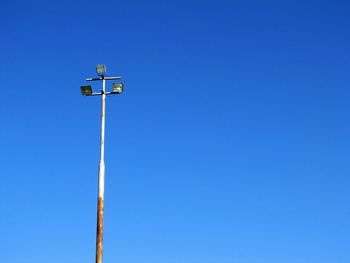 Low angle view of street light against blue sky