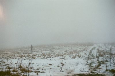 Scenic view of snowy field against sky during winter