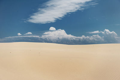 Scenic view of desert against blue sky