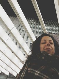 Portrait of woman standing on wall