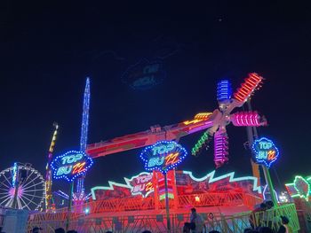 Low angle view of illuminated ferris wheel at night