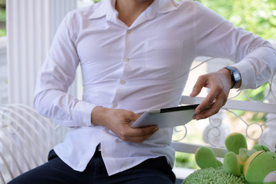 Midsection of woman using mobile phone