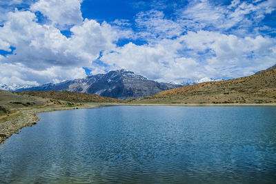 Scenic view of lake and mountains against sky