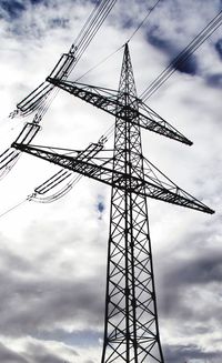 Low angle view of electricity pylon against sky