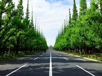 Road amidst trees against sky