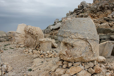 Stack of rocks on land against sky