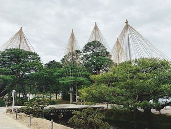 Gazebo by trees against sky