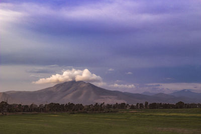 Scenic view of landscape against cloudy sky