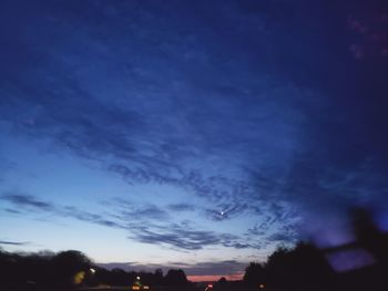 Low angle view of silhouette trees against sky at sunset
